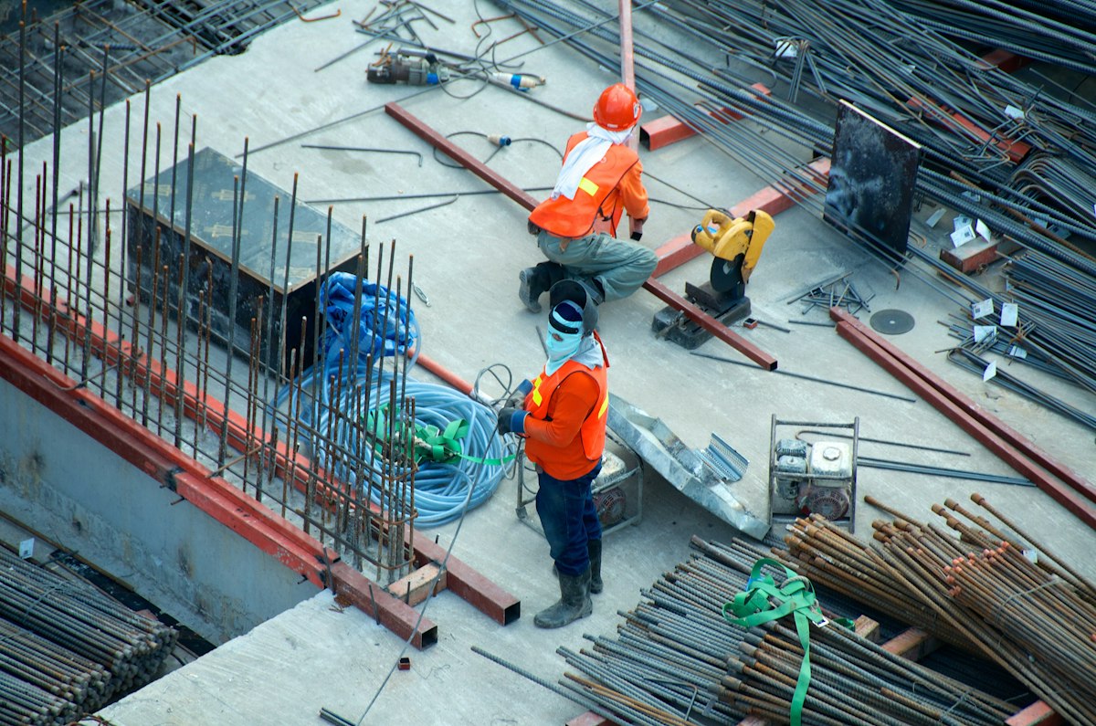 Trabajadores de construcción con cascos de seguridad en una obra industrial
